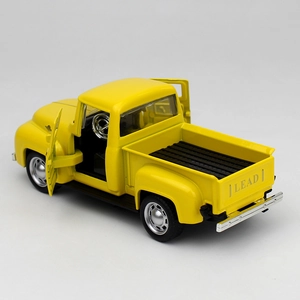 Detail of yellow alloy pickup truck toy showing openable doors and LEAD logo on the tailgate