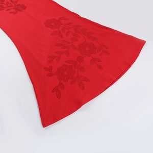 Detail shot of red floral rhinestone embellishments on an elegant evening dress
