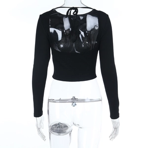 Detail of black slim fit cropped top featuring open back with decorative lace-up ties