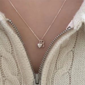 925 Sterling silver heart and key pendant necklace worn on a soft knitted sweater