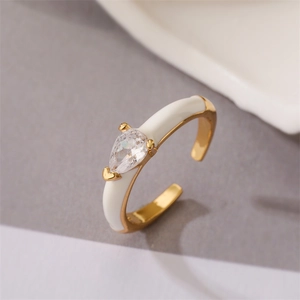 Golden teardrop ring with white enamel and sparkling zircon in an open adjustable design