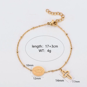Gold beaded bracelet with Mary oval medal and hollow cross pendant on white background