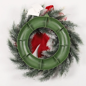 Christmas wreath with red bow and pine cones, showing a sturdy green plastic back frame