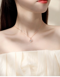 Close-up of rose gold sunflower necklace with sparkling moissanite stone on neck