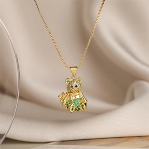 Detail of gold-plated bear pendant with sparkling green and clear zircon stones