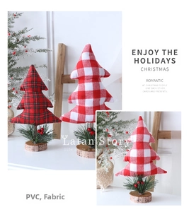 Detailed view of mini fabric Christmas trees with plaid patterns and real wood bases