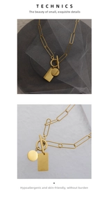 Detail view of gold stainless steel paperclip chain with OT toggle clasp and dual pendants