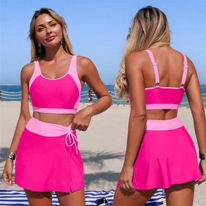 Women's two-piece pink patchwork swimsuit with adjustable straps and drawstring skirt