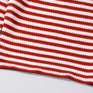 Macro shot of red and white striped knit fabric texture with fine honeycomb mesh weave