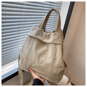 Close-up of lightweight nylon tote bag showing wrinkled texture and dual strap detail