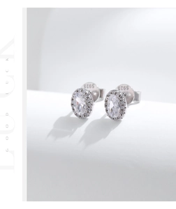 Macro shot of S925 sterling silver stamp on halo-set oval diamond earrings