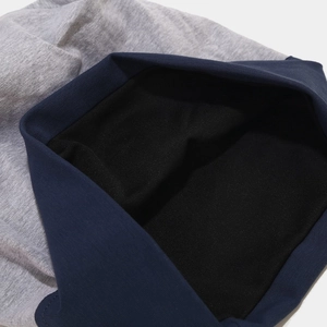 Detailed close-up of color-block knit beanie with thick ribbing and soft inner lining
