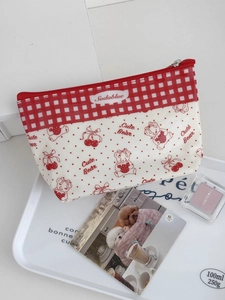 Macro detail of cherry and bear pattern on waterproof PVC cosmetic pouch with zipper