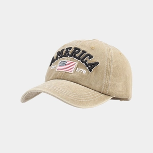 Detailed view of America and US flag embroidery on a vintage khaki baseball cap