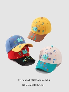 Close-up of colorful cartoon dinosaur patches and roar embroidery on kids' baseball caps