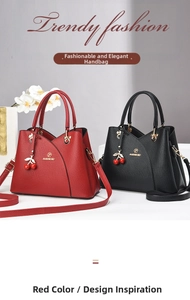 Detail of red and black lychee leather handbags with golden logo and cherry charms