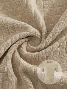 Macro detail of breathable waffle textured fabric on a men's beige short sleeve polo shirt
