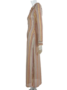 Detail of colorful geometric knit pattern and side slit on long sleeve maxi dress
