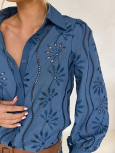 Close-up of blue shirt showing intricate floral embroidery and hollow-out lace details