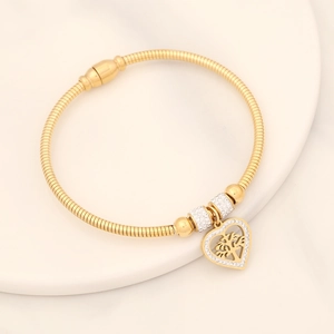 Golden snake chain bracelet featuring a heart pendant with tree of life and white zircons