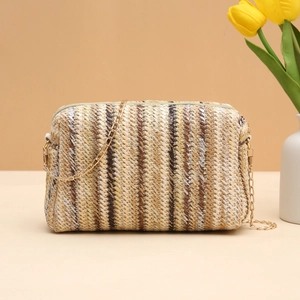 Colorful striped straw camera bag for women with golden chain strap on a warm background