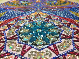 Macro shot of colorful rhinestones on a 5D DIY diamond painting Christmas wreath ornament