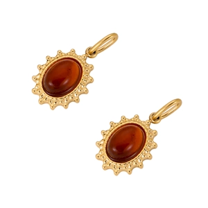 Detailansicht goldener Edelstahlanhänger mit Sonnenstrahl-Design und roten Steinen