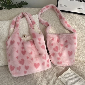 Cozy pink plush tote and bucket bag set with heart patterns on soft fleece background