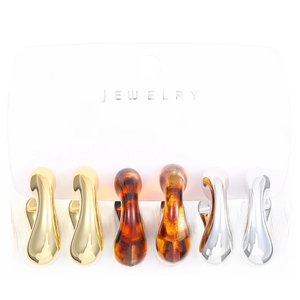 Close-up of vintage C-shape earrings set in gold, silver, and leopard resin texture