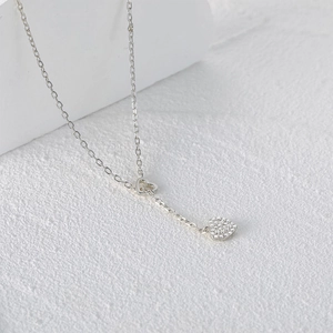 Detail showing the double heart pendants with crystals and hollow design on silver chain