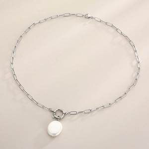 Detailed top view of silver paperclip chain necklace with a white baroque pearl pendant