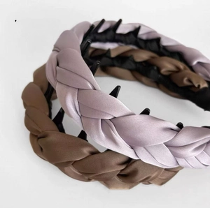 Close-up of woven satin headband in purple and coffee brown showing braided texture