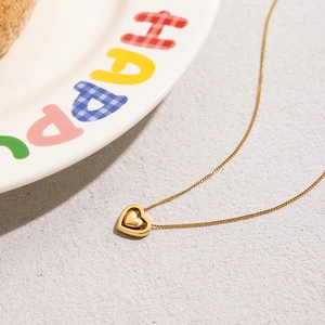 Macro shot of 18K gold plated stainless steel hollow heart pendant necklace detail