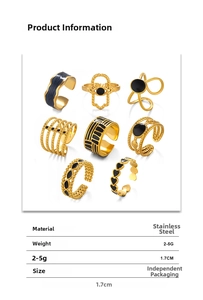 Detailed set of 8 gold stainless steel rings with black enamel heart and geometric patterns
