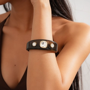 Detail of vintage resin cuff bracelet with sparkling crystals on a woman's wrist