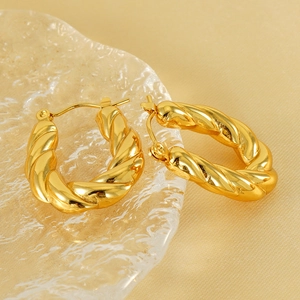 French style 18k gold plated stainless steel twisted hoop earrings on silk background