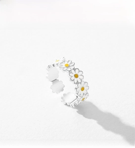 Detailed view of adjustable silver daisy ring with white and yellow enamel flower design