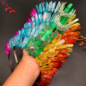 Detail of bohemian rainbow crystal headband with celestial sun and moon metal ornaments