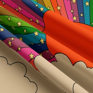 Close-up of bohemian rainbow tapestry fabric showing soft texture and vibrant star patterns