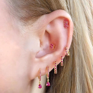 Close-up of gold-plated earrings set featuring pink zircon flowers and water drop charms