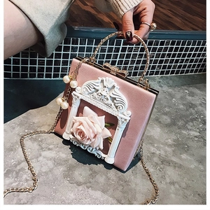 Close-up of pink flower box bag with 3D rose, baroque frame, and gold pearl chain