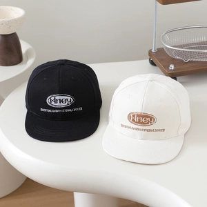 Kids hip-hop flat brim baseball cap with embroidered lettering in black and off-white