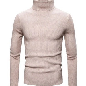 Detailed view of apricot turtleneck sweater featuring a vertical ribbed knit texture