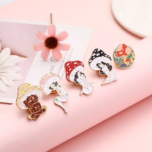 Creative mushroom woman enamel pin set in gold metal finish on pink surface