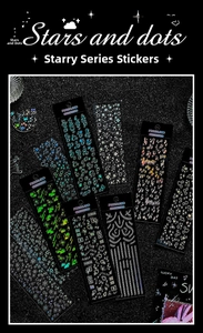 Macro shot of holographic laser stickers with music notes, stars, and cloud patterns
