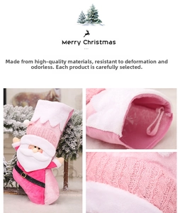 Detail showing the pink plush fabric, hanging rope, and knitted texture of the Christmas sock