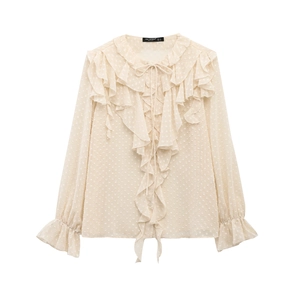 Detail of French style blouse with beige polka dot chiffon texture and ruffled trim
