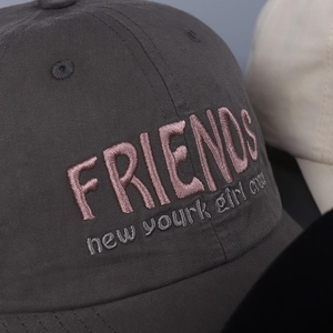 Dark grey cotton baseball cap featuring pink 3D embroidered Friends logo and soft texture