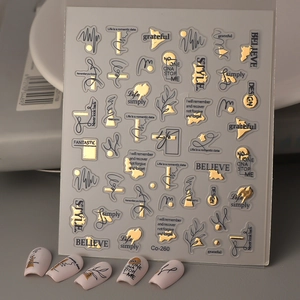 Gold and black nail art stickers with elegant English lettering and minimalist lines
