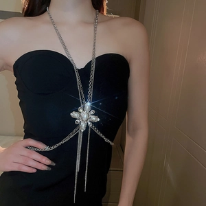 Close-up of silver body chain featuring a pearl flower centerpiece and elegant long tassels